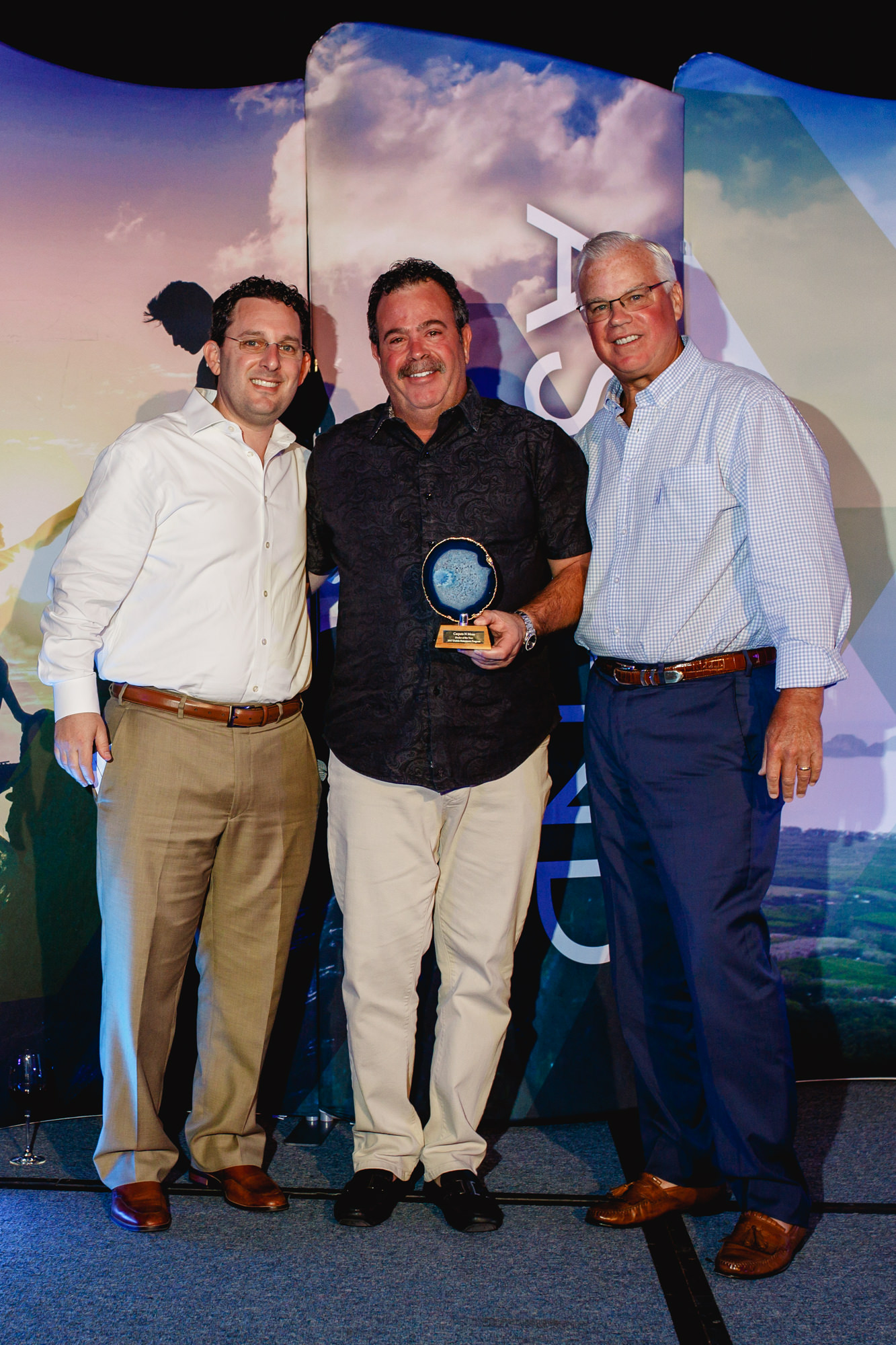 Steve Chesin of Carpets N More named Statements Dealer of the Year (c.) with Daltile's Jeremy Sax (l) and John Cousins.