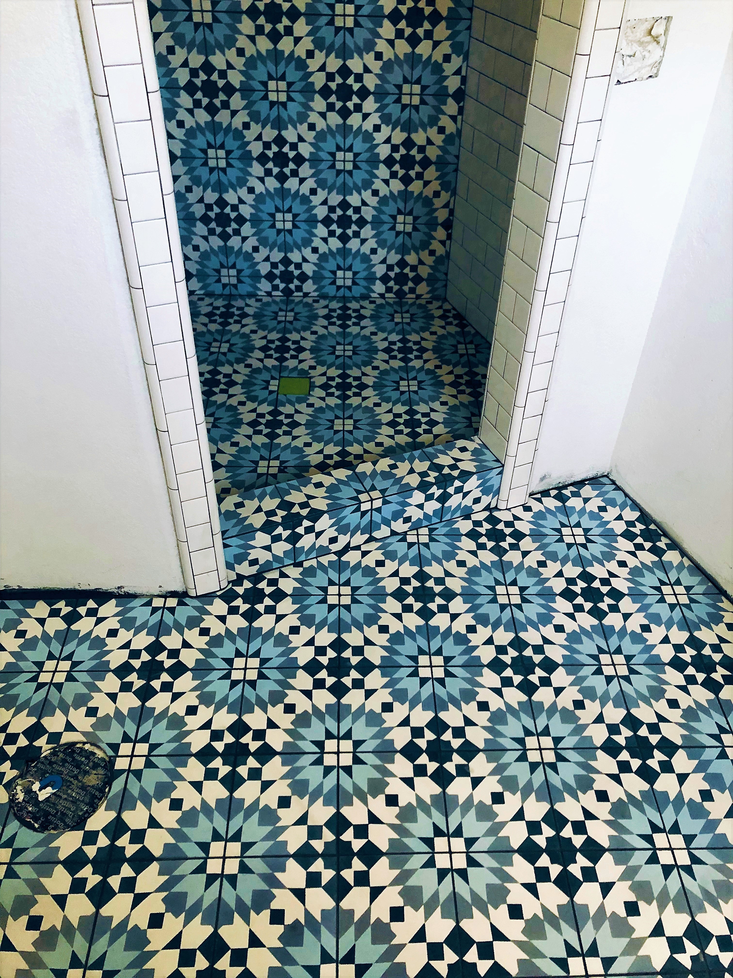 This shower featured blue encaustic tile with 3”x 6” subway tile.