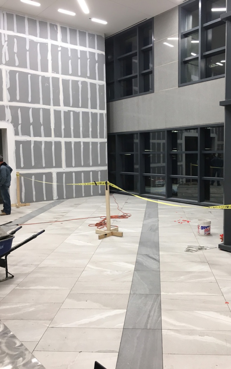 After installing floor tiles, David Allen Company prepped the walls for the large-format gauged panel installation.