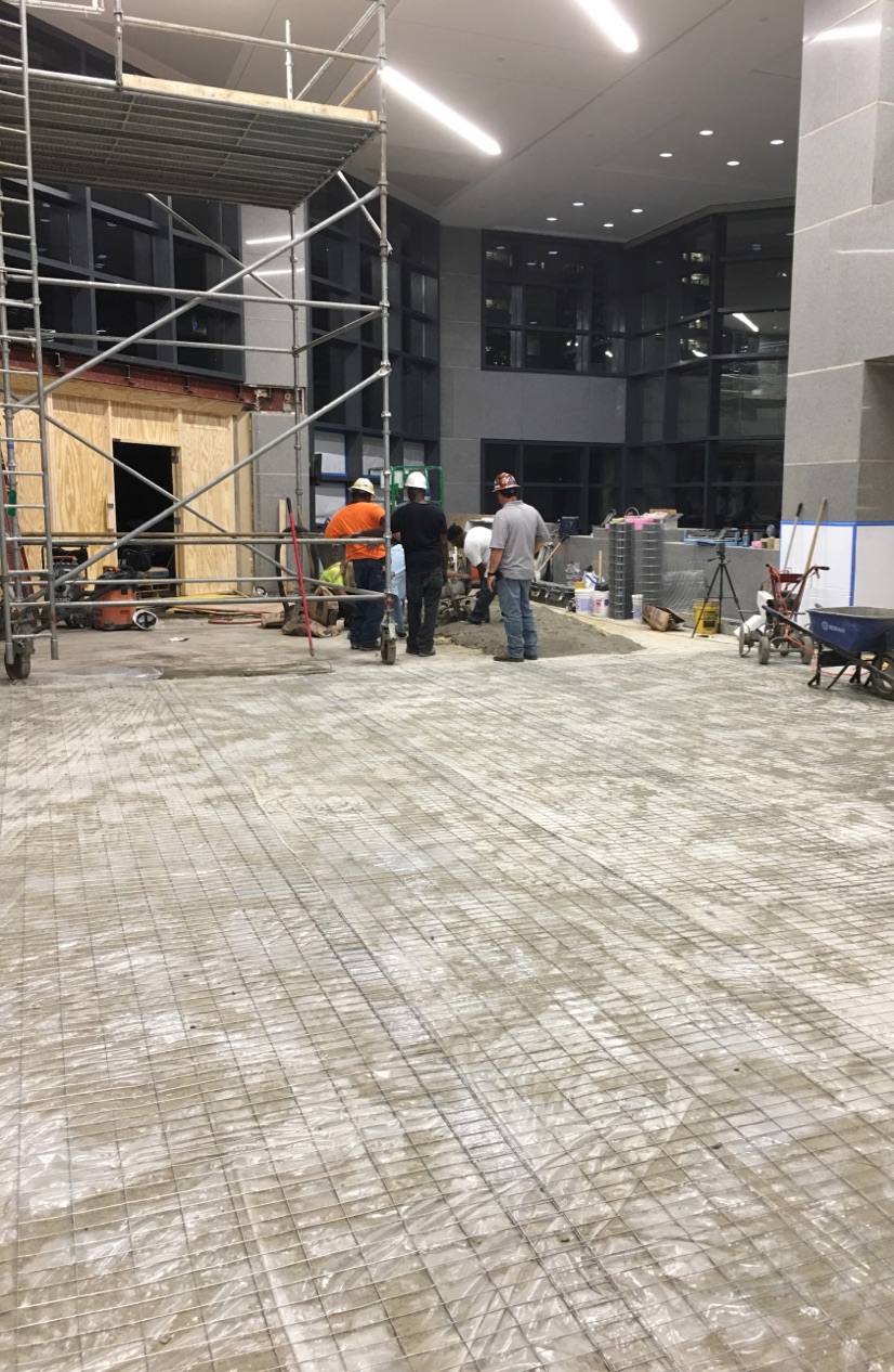 Prepping the floors in the lobby for installation.