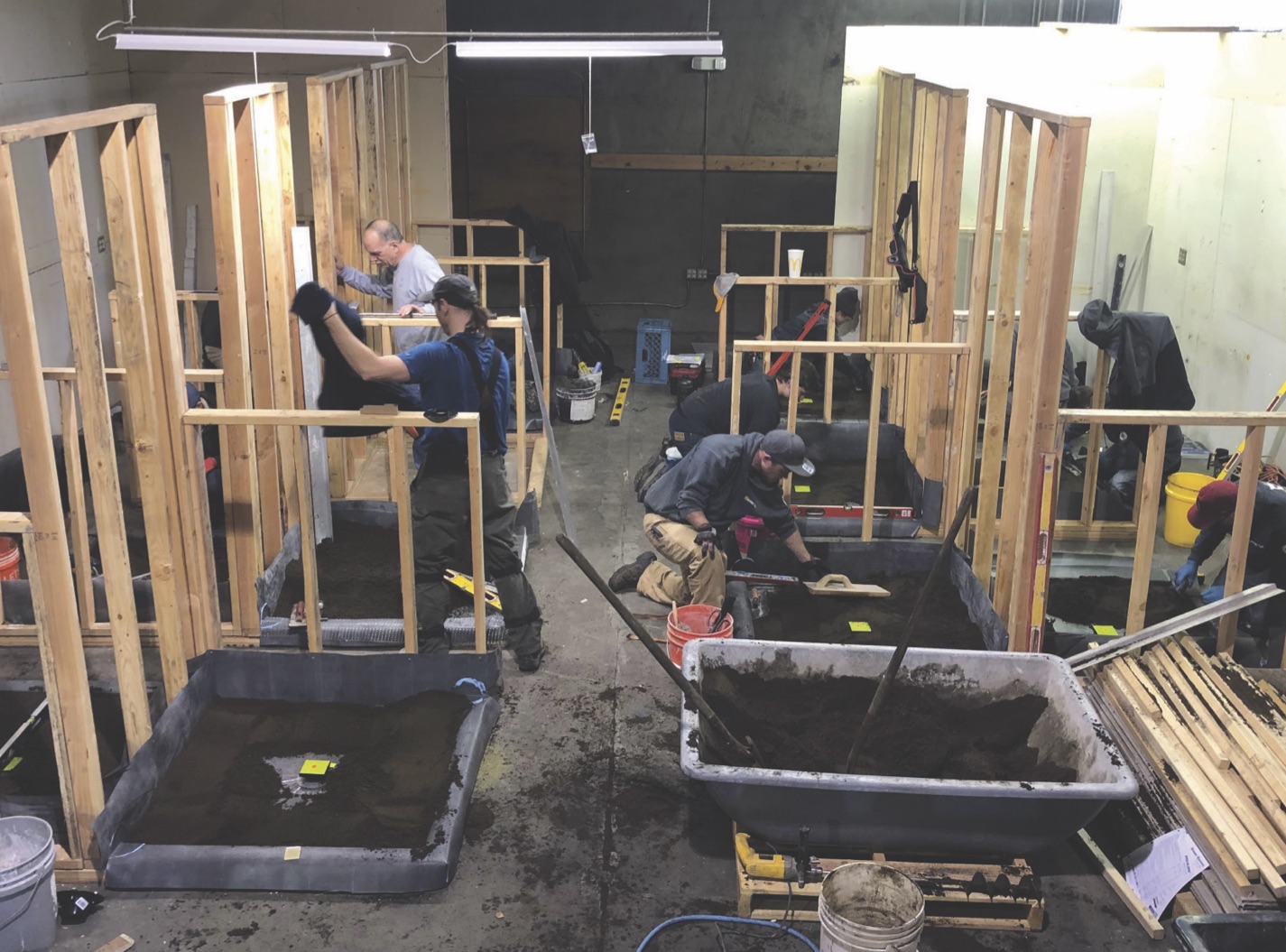 Apprentices constructing shower pans.